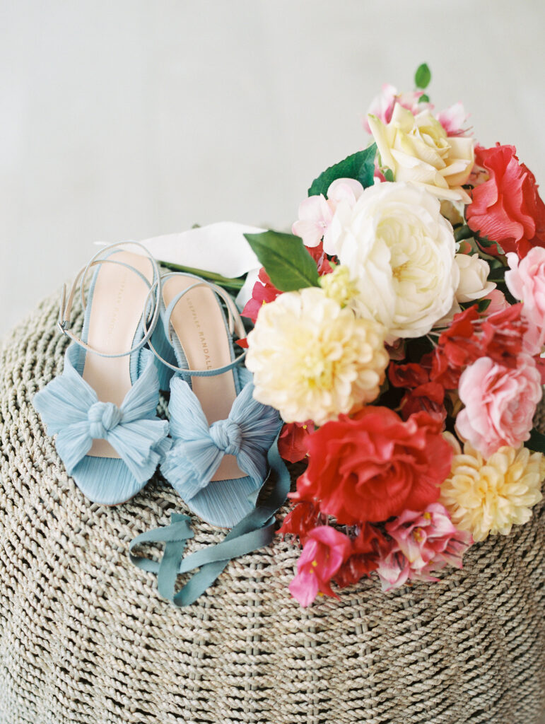 Colorful bridal bouquet and blue bridal shoes