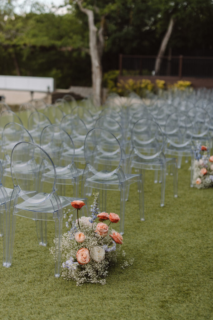 Modern aisle markers made of baby's breath and pastel flowers placed on the ground for outdoor wedding