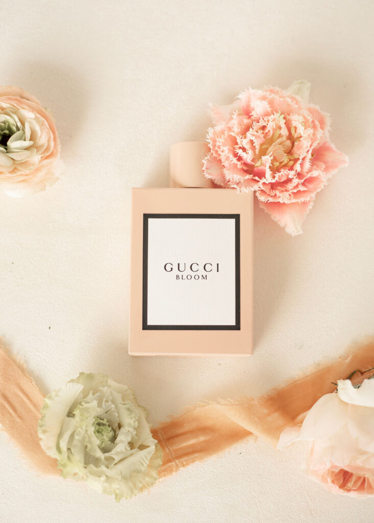 Pink Gucci perfume bottle with accenting blooms, featuring pink tulips